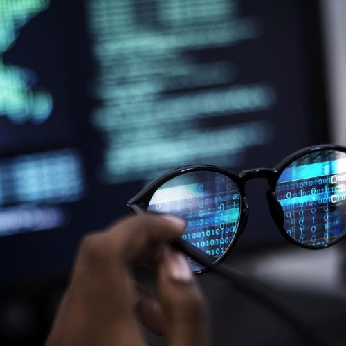 closeup-of-a-man-holding-a-pair-of-glasses-8EQEGMB